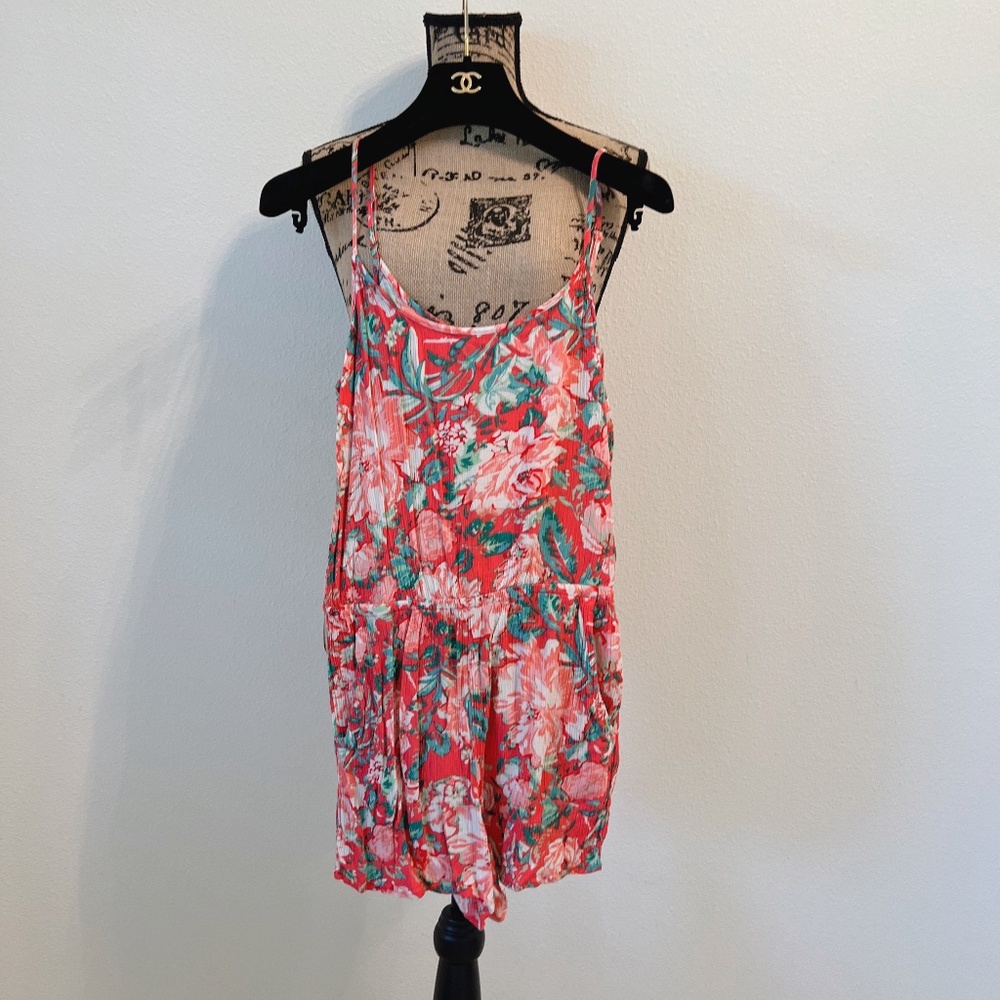 Forever 21 floral romper with cutout back and pockets.